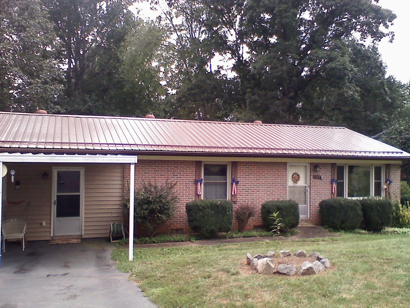 Bronze metal roof and carport on a brick ranch home — Roof Repair work by our crew in Selinsgrove